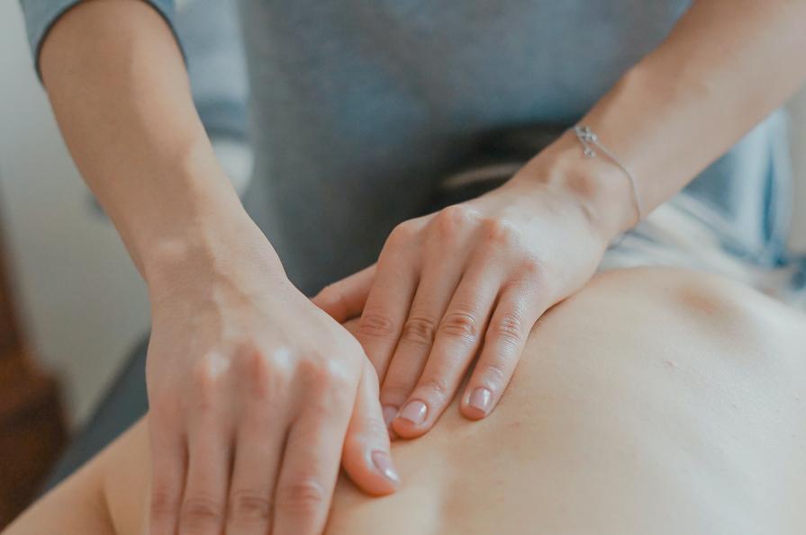 Hands massaging persons back