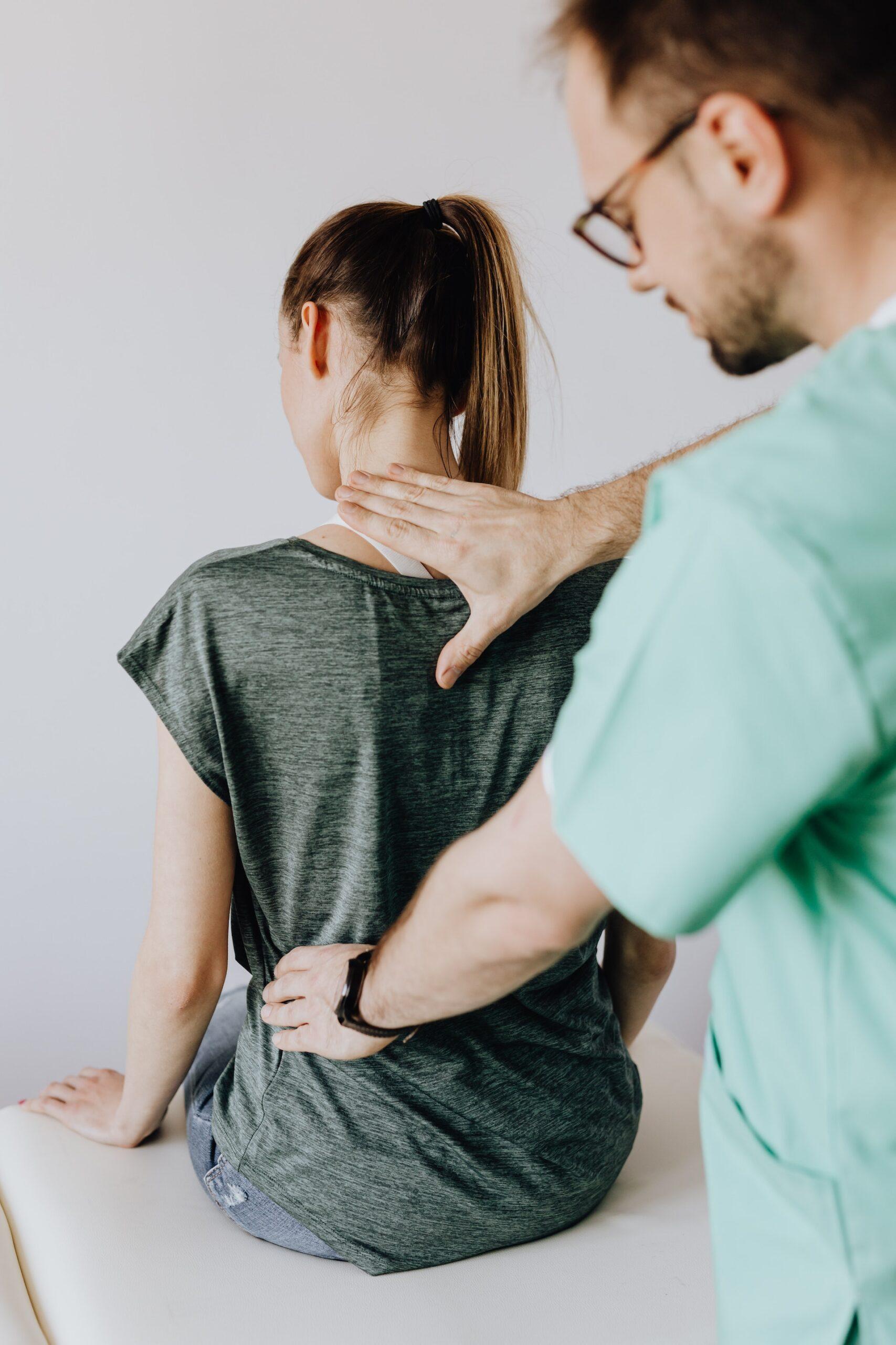 Chiropractor performing a back examination on the patient