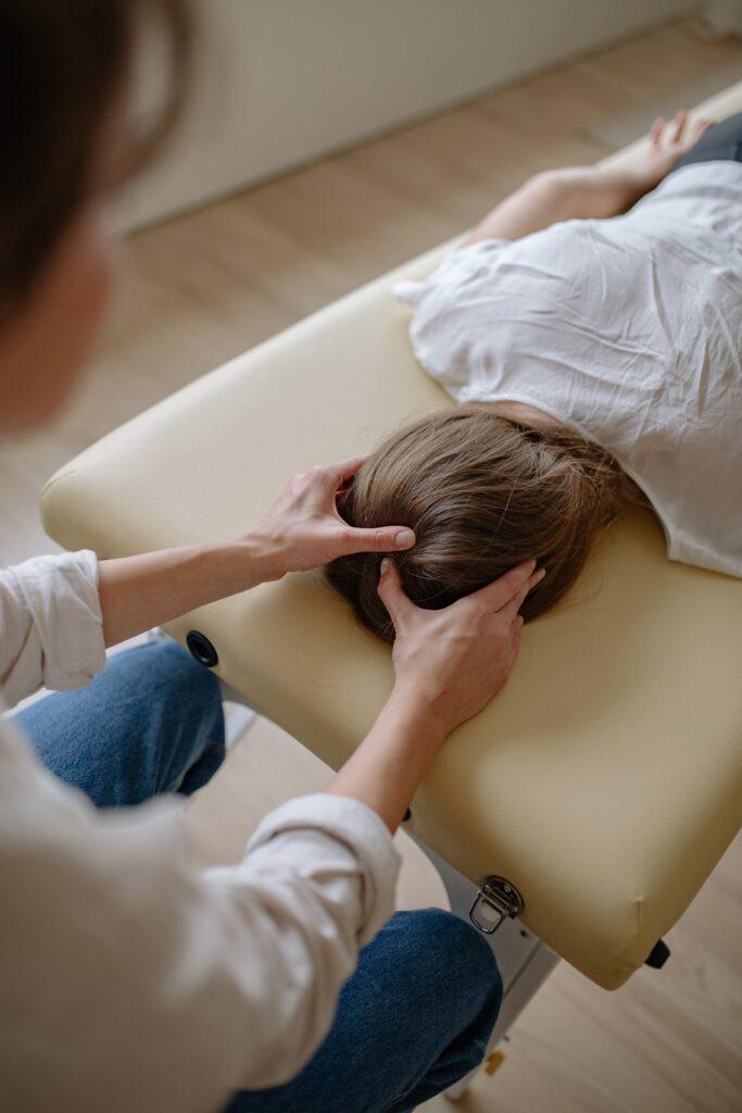 A woman give a head massage to another woman