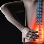 A man stands facing away and places his hand on his lower back where a superimposed spine is glowing red.